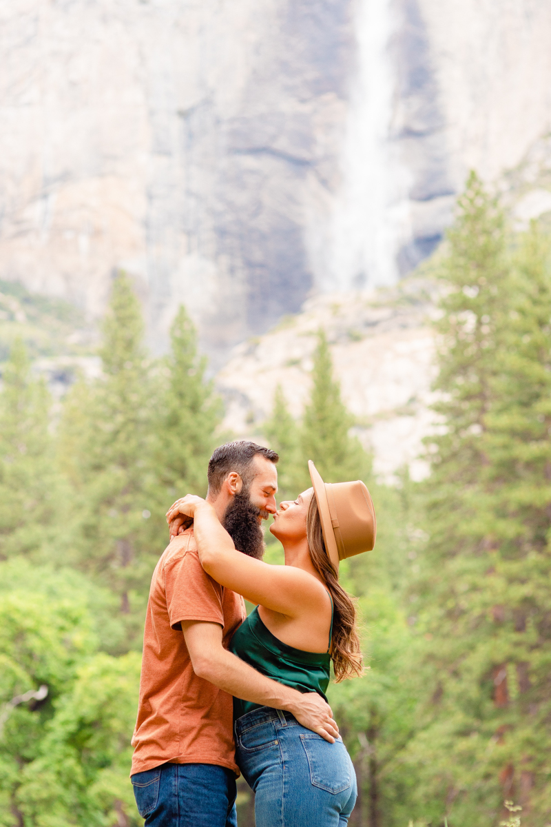 Woman kisses her fiancé on the nose during their engagement session at Yosemite.